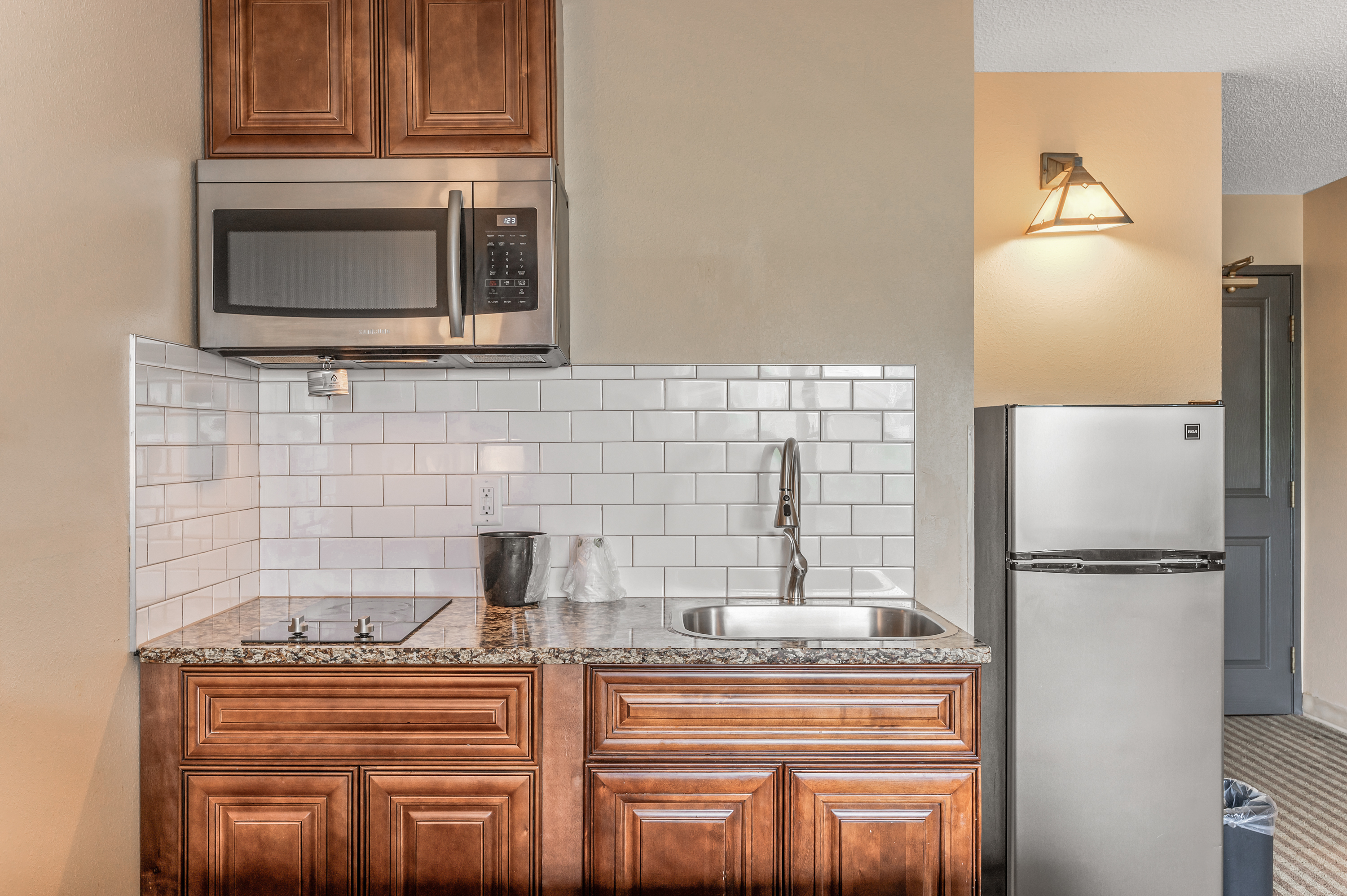 Kitchenette counter with cooktop and sink at TownSquare Place